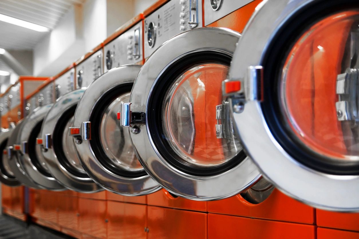 row of washing machines in laundromat